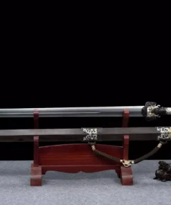 A decorated dragon handle sword Jian, displayed next to its scabbard, on a small wooden sword-stand.
