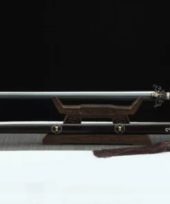A fire dragon sword Jian weapon, displayed on a wooden stand, with its decorative scabbard below on the floor.