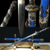 A Chinese flying dragon sword Jian, displayed against its decorative blue scabbard, on a small wooden sword-stand.