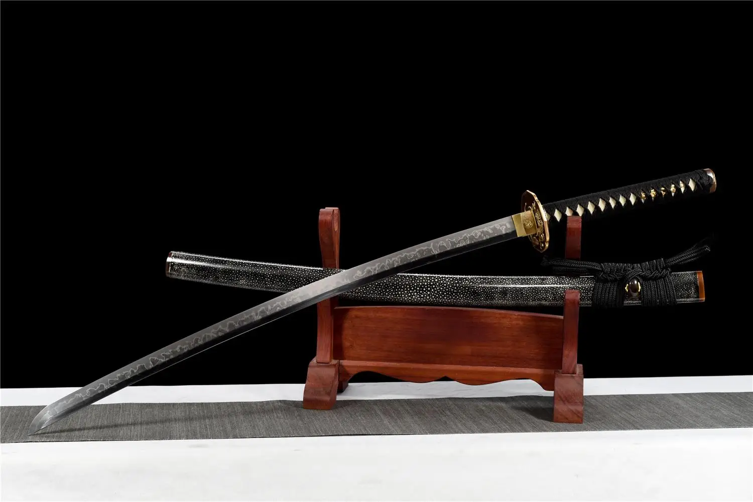 Gold Dragon Sword A gold dragon sword Katana displayed next to its scabbard, on a small wooden sword-stand.