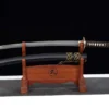 A Japanese Wakizashi sword and its scabbard displayed on a wood stand.