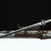 A sacred moonlight sword Jian, displayed leaning against a small wooden stand, with its decorative scabbard below on the floor.