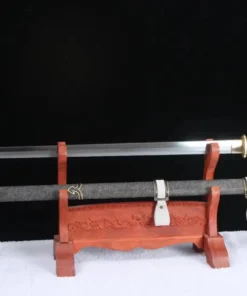 A straight, single edged sword and its scabbard displayed on a wooden stand.