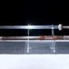 A two handed Jian sword displayed next to its decorative scabbard on a small plastic stand.