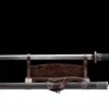 A straight, Chinese war swprd displayed on a small wood stand, with its scabbard below on the floor.