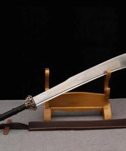 A Chinese warrior sword scimitar, leaning against a small wooden stand, with its leather scabbard on the floor below.