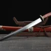 A Chinese curved Short sword, displayed next to its scabbard, leaning against a small wooden stand.
