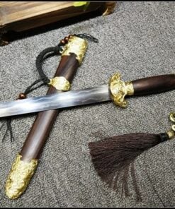 A Damascus dagger knife, with a straight, double edged blade, displayed crossed-over its decorative sheath on the floor.