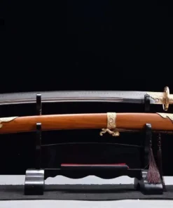 A Dao Chinese sword saber and its decorative scabbard displayed on a small wooden sword stand.