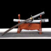 A wood Chisa Katana and its scabbard displayed on a small wooden stand.
