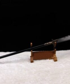 A nine ring Guan Dao polearm displayed on a small wooden stand.
