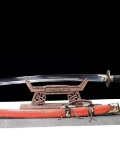 A Chinese Liuyedao sword saber, displayed on a small wooden stand, with its scabbard below on the floor.
