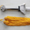 A retracted telescopic Tai Chi Sword with a yellow sword tassel.