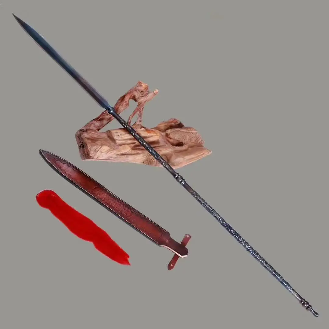 Steel Spear A long folded steel spear weapon, displayed leaning on a wood log, next to its scabbard and tassel.