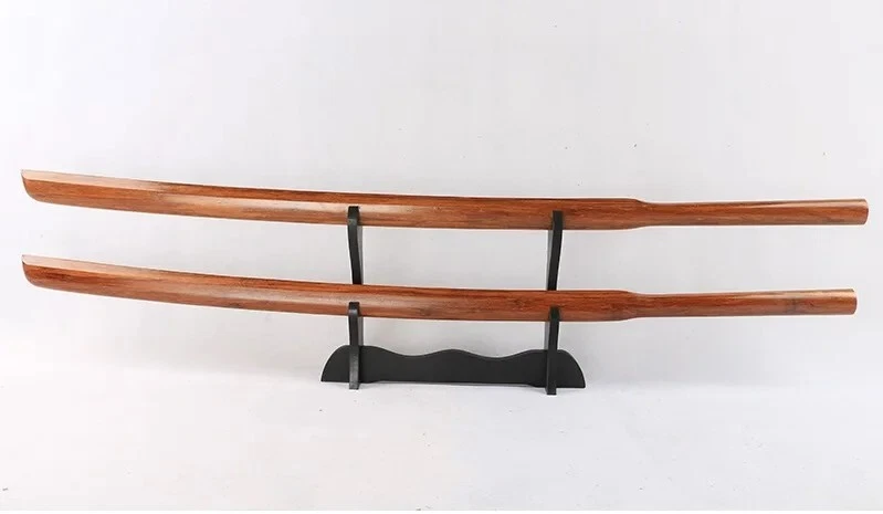 Suburito Two wooden Suburito bokken swords displayed on a small wood sword-stand.