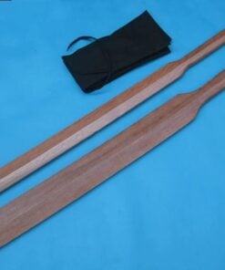 Two Suburi bokken swords of differing sizes laying on a blue colored floor.