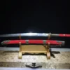 A Chinese two handed saber sword, displayed next to its scabbard, on a small wooden stand.