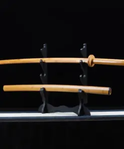 A bamboo Katana sword displayed next to its scabbard, on a small sword-stand.