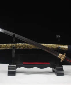 A Japanese Katana and its decorative scabbard, displayed on a small wooden sword stand.