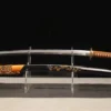 A brown Katana sword displayed next to its decorative scabbard, on a small stand.