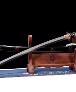 A folded steel clay tempered Katana displayed next to its scabbard, on a small sword-stand.