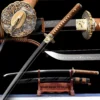 A mirror blade display Katana, displayed next to its scabbard, on a small wooden sword-stand.