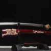 A beautiful Katana sword and its decorative scabbard displayed on a small sword stand.