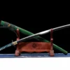 A Shinken green Katana sword displayed next to its scabbard, leaning against a small wooden stand.