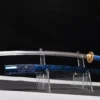 A Katana blue sword, displayed next to its scabbard, on a small plastic sword-stand.