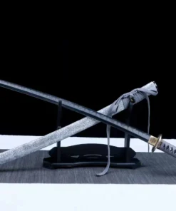 A Japanese long sword and its scabbard leaning against a small sword stand.