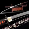 A display Katana with a mirror blade shine, displayed next to its decorative scabbard, on a small wooden sword-stand.