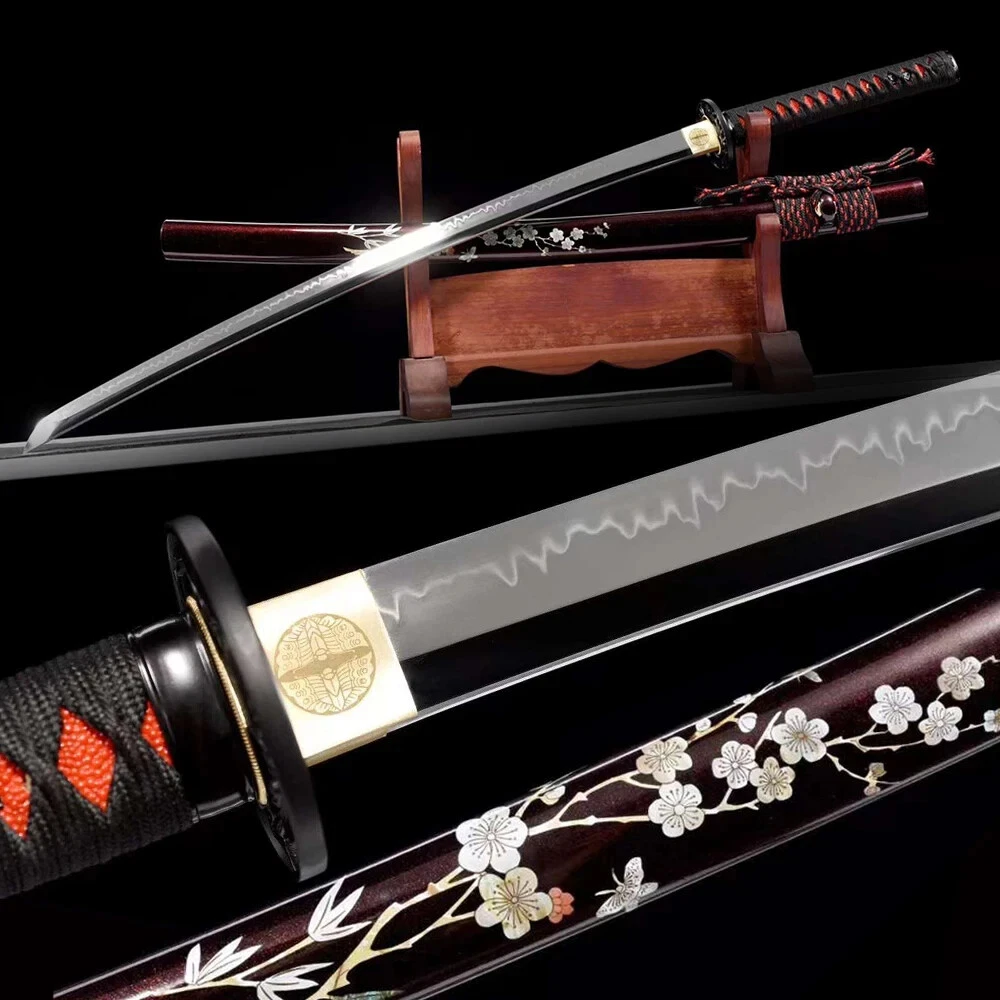 Mirror Blade A display Katana with a mirror blade shine, displayed next to its decorative scabbard, on a small wooden sword-stand.
