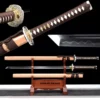 Two Ninjato Katana swords displayed on a wooden stand, one sheathed and the other displayed with its scababrd below. And sword highlights above.