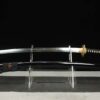 A Japanese snake sword Katana displayed on a small stand alongside its scabbard.