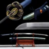 A Japanese, Samurai Katana sword with a snake Tsuba and its scabbard displayed on a wooden stand.