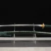 A Japanese Katana sword and its scabbard displayed on a small stand.