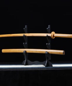A bamboo wooden Katana sword displayed next to its wood scabbard, ona small sword-stand.