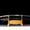 A 1095 steel Katana saber displayed next to its black scabbard, on a wooden sword-stand.