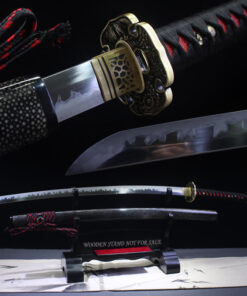 A black and red Katana sword, displayed on a wooden stand, alongside its scabbard.