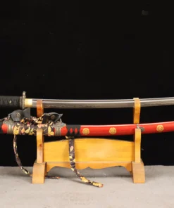 A Tachi cavalry sabre displayed next to its decorative scabbard, on a small wooden stand.