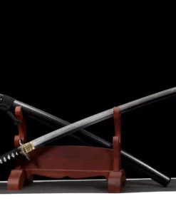 A curved Katana sword displayed crossed against its black scabbard, leaning against a small wooden sword-stand.