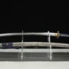 A Katana flower sworddisplayed next to its scabbard, on a small stand.