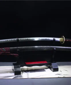 A red and black sword Katana displayed next to its scabbard, on a small wooden stand.