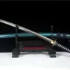 A T10 steel sword displayed next to its scabbard, leaning against a small wooden stand.