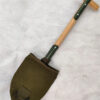 A US army shovel with a canvas sheath.