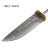 A Damascus knife blade blank displayed with a brass hand-guard.