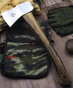 A small forest hatchet with a wood handle, displayed against a camouflage bag, on a wooden floor.