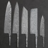 Five Damascus steel kitchen knives of differing design.