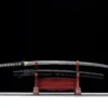 A black Katana sword and its scabbard displayed on a small wooden stand.