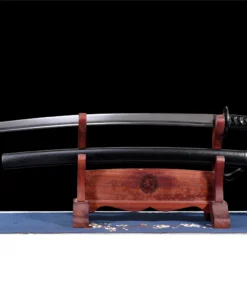 A dull Katana training sword displayed next to its black scabbard, on a small wooden stand.